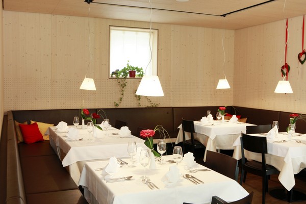 Restaurang med dukade bord p hotell Pustertalerhof i Kiens, Dolomiterna.